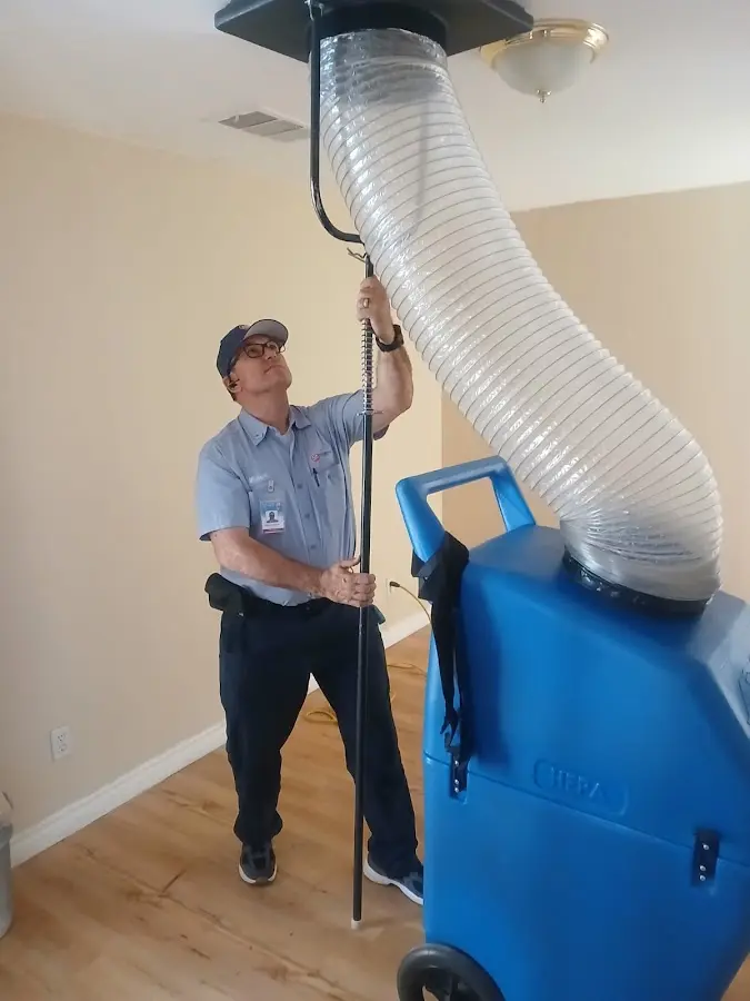 Furnace Tune-Up technician using HEPA equipment in Nederland